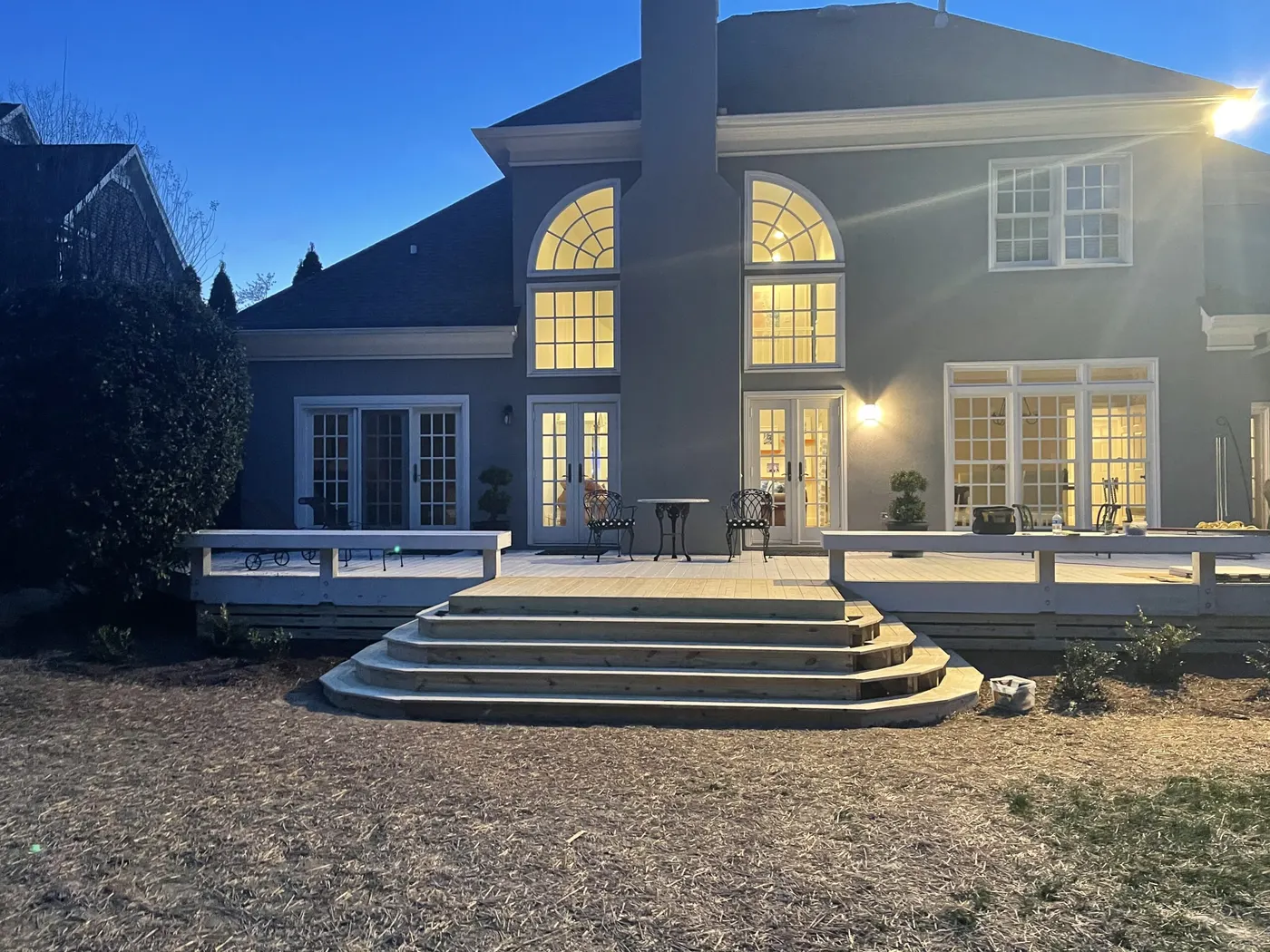 Deck with wide curved steps at dusk