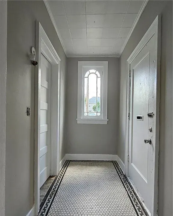 Hallway with mosaic tile floor