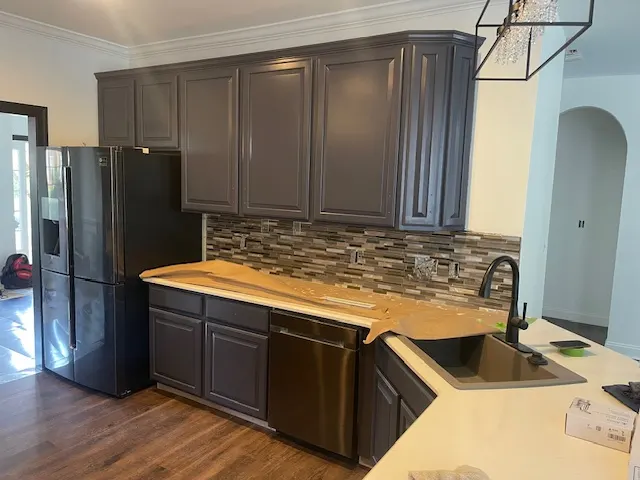 Kitchen with dark cabinets and stainless appliances