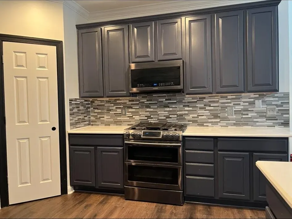 Navy kitchen cabinets with range and microwave