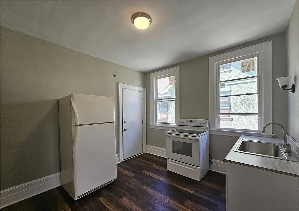 Kitchen with white cabinets and new flooring