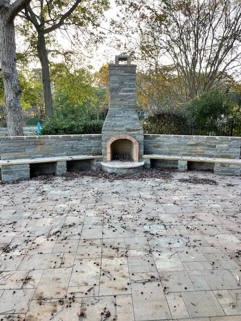 Outdoor fireplace with stone seating wall