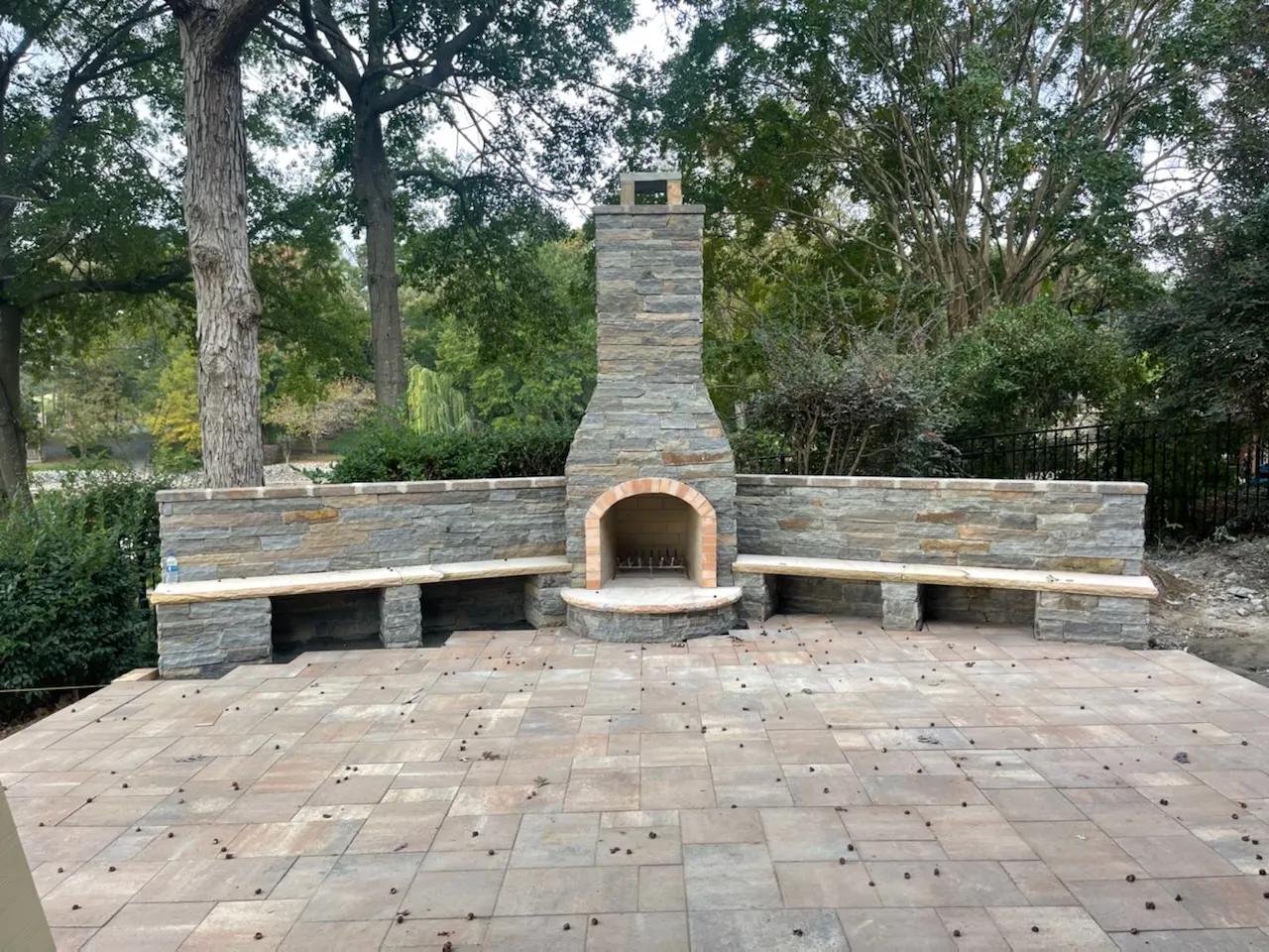 Stone outdoor fireplace with paver patio