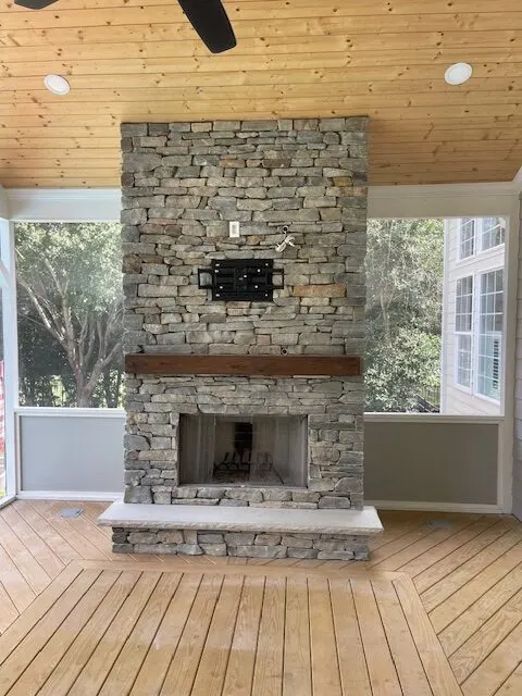Stone fireplace on a covered porch